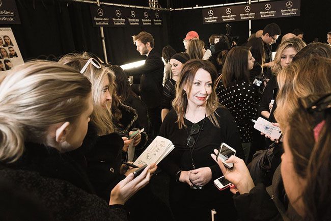 Lippmann surrounded by reporters at New York Fashion Week
