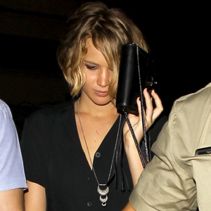 Jennifer Lawrence hides behind her handbag after the Chris Martin Concert.