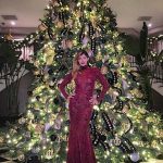 Brittny also posed in front of the Jenner tree; her dress was maroon lace