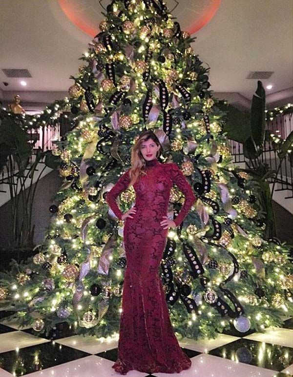 Brittny also posed in front of the Jenner tree; her dress was maroon lace
