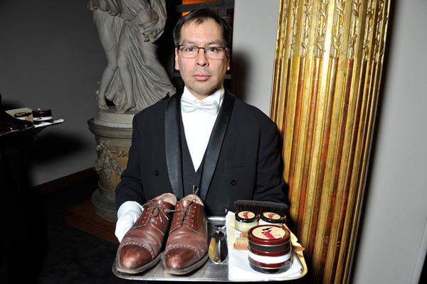 A waiter profers a Berluti shoe shine kit