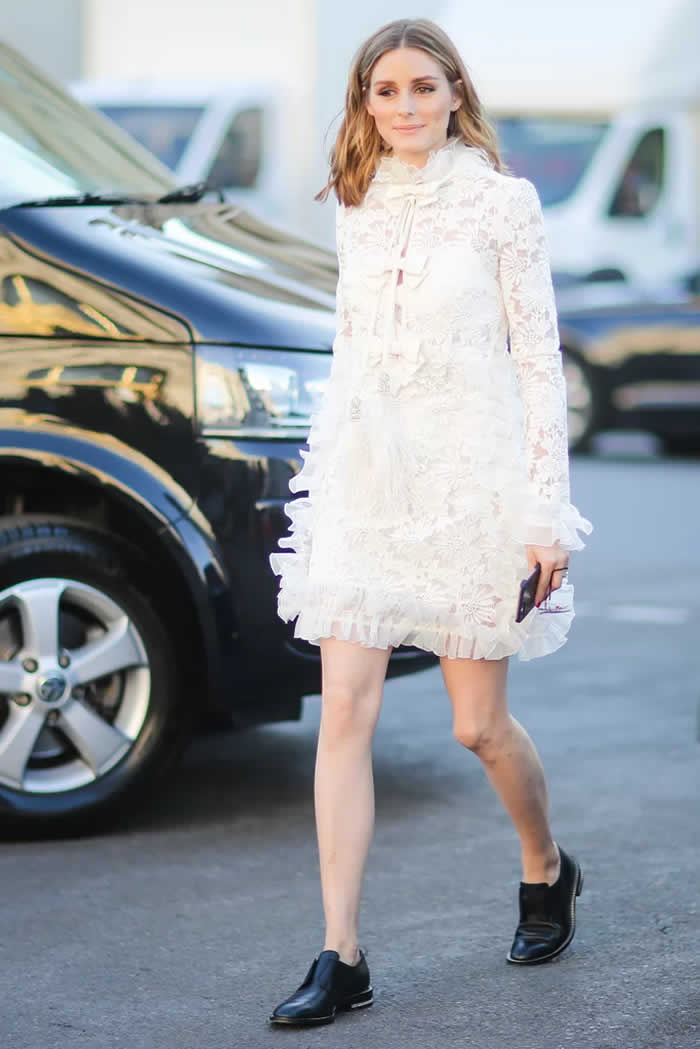 Olivia Palermo smartly grounded her lacy, frilly number with black leather loafers.